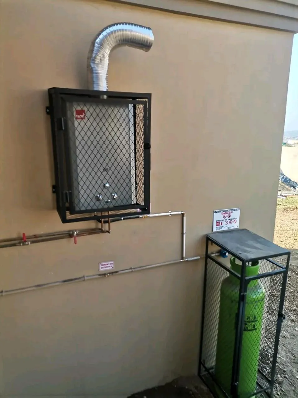 Caged gas heater with flue ducting
